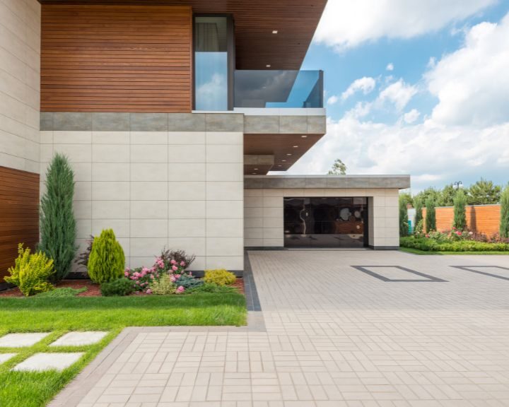 A city house with a concrete driveway.